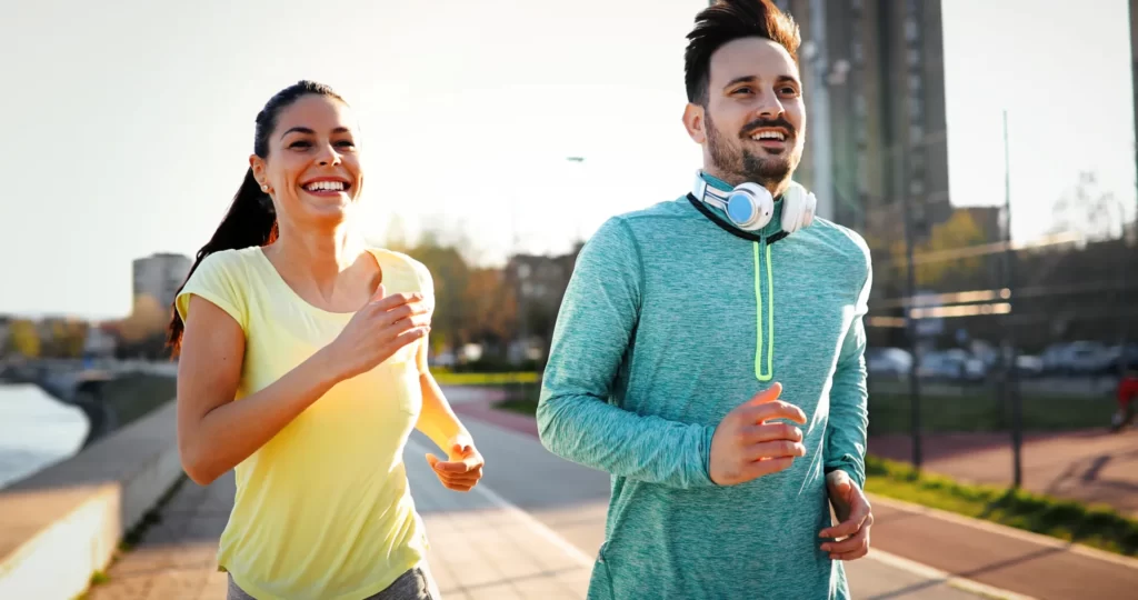 young fitness couple running in urban area utc